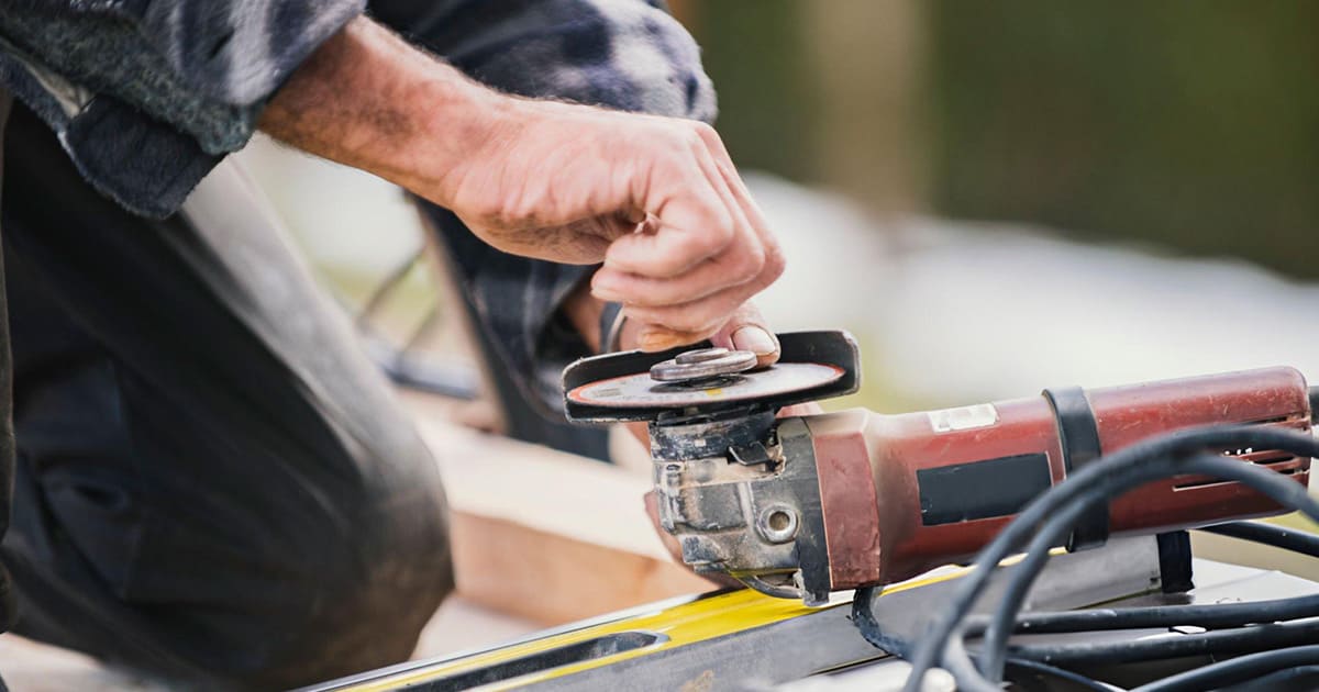 a worker is changing the angle grinder's blade.