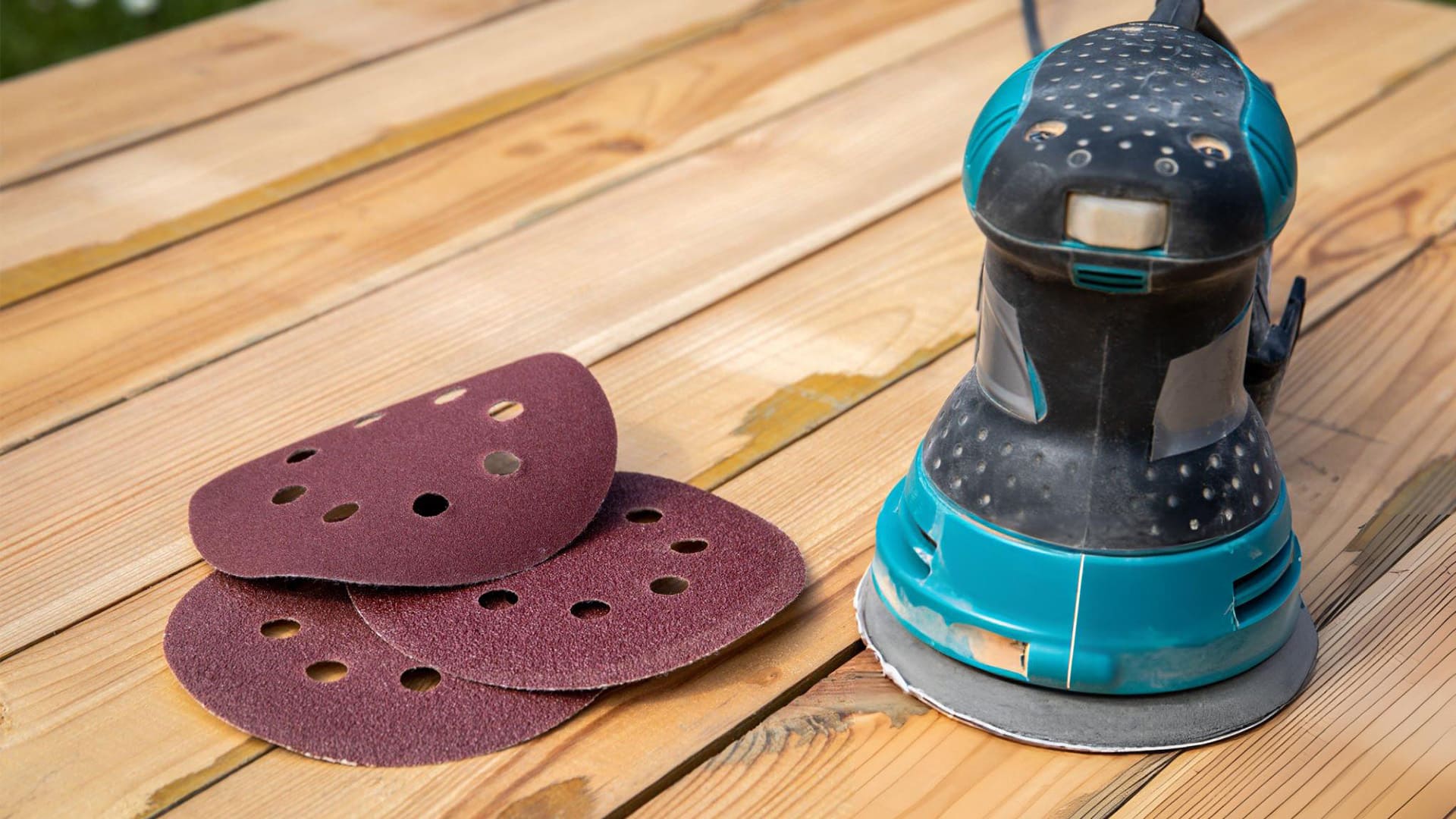  an orbital sander and different types of sanding pad